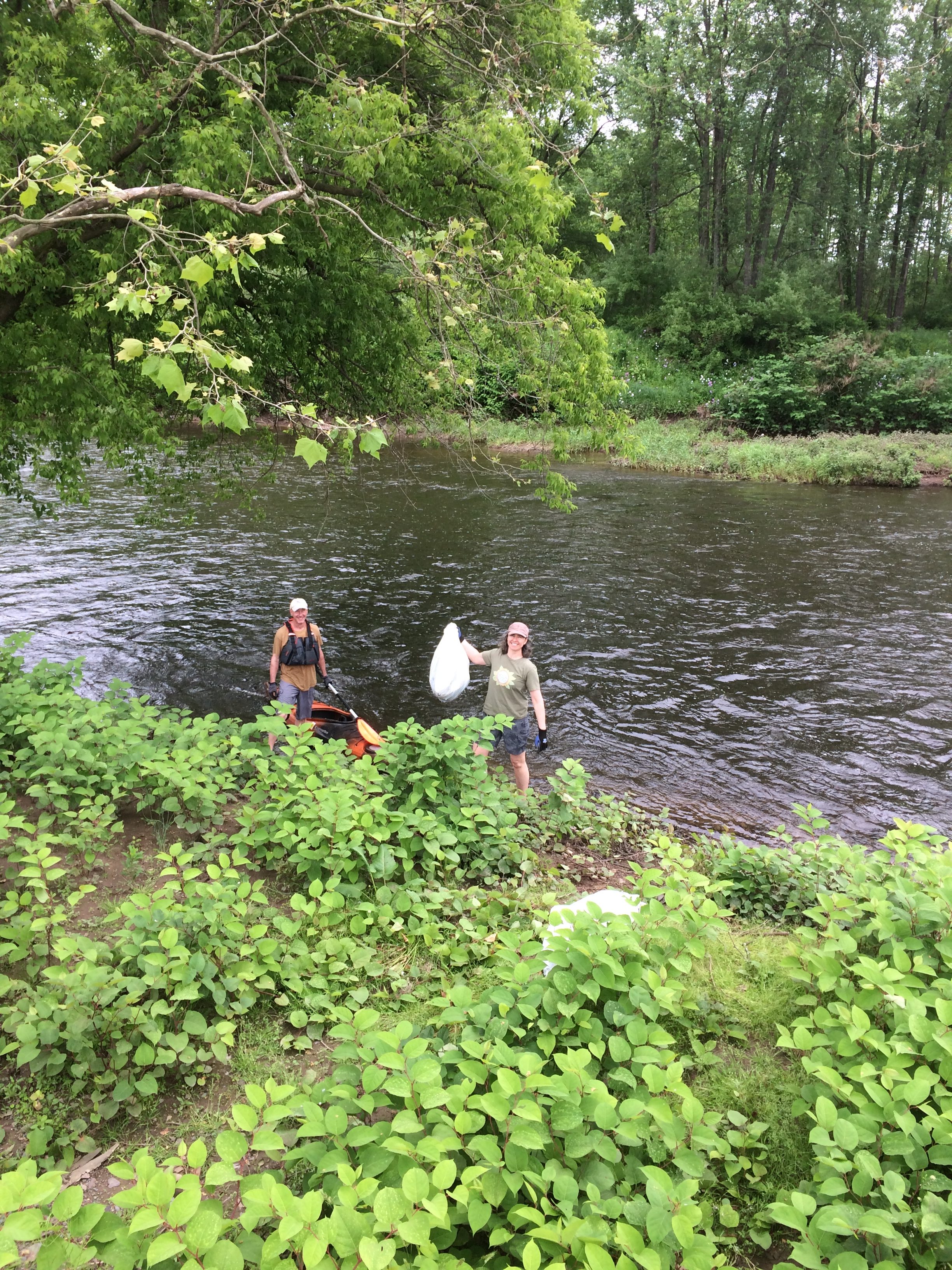 Photo of SEEDS board member David Ford and volunteer Krista Gromalski cleaning up a riparian zone on the Lackawaxen River.